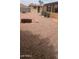 Large backyard featuring a shed, gravel landscaping, and ample room for outdoor activities and gardening at 962 S Main Dr, Apache Junction, AZ 85120