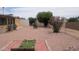 Spacious backyard featuring lush greenery, gravel landscaping, and potential space for various outdoor activities at 962 S Main Dr, Apache Junction, AZ 85120