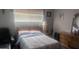 Neutral bedroom with natural light, bed, dresser, and comfortable seating at 962 S Main Dr, Apache Junction, AZ 85120