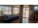 The bedroom features a comfortable bed near a large window with sliding glass door for outdoor access at 962 S Main Dr, Apache Junction, AZ 85120