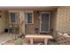 Inviting front porch with cozy seating area, stone bench, and decorative landscaping adding curb appeal at 962 S Main Dr, Apache Junction, AZ 85120