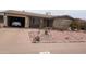 Charming front exterior features a landscaped yard and covered parking at 962 S Main Dr, Apache Junction, AZ 85120