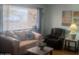A comfortable living room area featuring neutral colored walls and laminate flooring at 962 S Main Dr, Apache Junction, AZ 85120