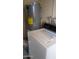Functional utility space with a water heater, washer, and dryer for essential home services at 962 S Main Dr, Apache Junction, AZ 85120