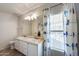 Bright bathroom featuring a double vanity, a large mirror, and natural light at 10557 W Louise Dr, Peoria, AZ 85383