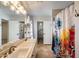 Bathroom with double sinks, a large mirror, and colorful shower curtains at 10557 W Louise Dr, Peoria, AZ 85383