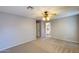 Spacious bedroom featuring neutral walls with a doorway to an ensuite bathroom at 10557 W Louise Dr, Peoria, AZ 85383