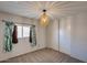 Cozy bedroom with plush carpeting, window with light-filtering blinds, and a closet with sliding doors at 10557 W Louise Dr, Peoria, AZ 85383