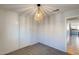 Clean bedroom featuring neutral walls, carpet, closet with sliding doors, and modern light fixture at 10557 W Louise Dr, Peoria, AZ 85383
