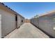 Wide driveway features handsome pavers, leading to a gate that secures the backyard at 10557 W Louise Dr, Peoria, AZ 85383