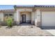 Welcoming front entrance with a decorative security door, desert landscaping, and a tiled walkway at 10557 W Louise Dr, Peoria, AZ 85383