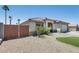 Charming single-story home with a tiled roof, desert landscaping, and an attached two-car garage at 10557 W Louise Dr, Peoria, AZ 85383