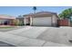 Inviting single-story home with desert landscaping, a tiled roof, and an attached two-car garage at 10557 W Louise Dr, Peoria, AZ 85383