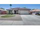 Charming single-story home with desert landscaping, a tiled roof, and a two-car garage at 10557 W Louise Dr, Peoria, AZ 85383