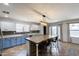 Beautiful kitchen with a large island featuring seating, two-tone cabinetry, and access to the outdoors at 10557 W Louise Dr, Peoria, AZ 85383