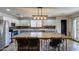 Spacious kitchen with two-tone cabinets, stainless steel appliances, and a large island with seating for dining at 10557 W Louise Dr, Peoria, AZ 85383
