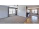 Bright and airy living room with neutral carpet and a large window at 10557 W Louise Dr, Peoria, AZ 85383