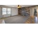 Stylish living room showcasing a decorative wood accent wall and large bright windows at 10557 W Louise Dr, Peoria, AZ 85383