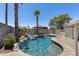 Private backyard oasis with a sparkling pool, rock waterfall feature, and lush landscaping at 10557 W Louise Dr, Peoria, AZ 85383