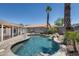 Sparkling private swimming pool with lush tropical landscaping and boulder accents at 10557 W Louise Dr, Peoria, AZ 85383