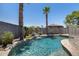 Beautiful pool with mature palms and landscaping, plus an enchanting waterfall feature at 10557 W Louise Dr, Peoria, AZ 85383