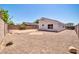 A private backyard featuring gravel landscaping, a patio area, and a block wall for added seclusion at 11154 W Ashley Chantil Dr, Surprise, AZ 85378