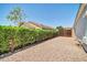 Gravel yard features a hedge fence and gated access at 11154 W Ashley Chantil Dr, Surprise, AZ 85378