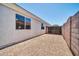 Sideyard featuring gravel, a gate, and mature block fence at 11154 W Ashley Chantil Dr, Surprise, AZ 85378