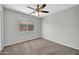 This bedroom offers neutral walls, carpet, and a bright window at 11154 W Ashley Chantil Dr, Surprise, AZ 85378