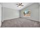 Bright bedroom with neutral carpet and a view of the backyard at 11154 W Ashley Chantil Dr, Surprise, AZ 85378