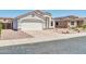 Charming single-story home featuring a stucco exterior, a two-car garage and low maintenance desert landscaping at 11154 W Ashley Chantil Dr, Surprise, AZ 85378