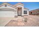 Charming single-story home featuring a stucco exterior, a two-car garage and low maintenance desert landscaping at 11154 W Ashley Chantil Dr, Surprise, AZ 85378