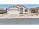 Charming single-story home featuring a stucco exterior, a two-car garage and low maintenance desert landscaping at 11154 W Ashley Chantil Dr, Surprise, AZ 85378