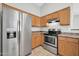 Well-lit kitchen boasts stainless steel appliances, ample cabinet space, and tile flooring at 11154 W Ashley Chantil Dr, Surprise, AZ 85378