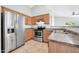 Bright kitchen featuring stainless steel appliances, wooden cabinets, and easy access to the living area at 11154 W Ashley Chantil Dr, Surprise, AZ 85378