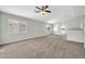 Spacious living room with neutral paint, carpet flooring, and an open concept design at 11154 W Ashley Chantil Dr, Surprise, AZ 85378