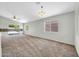 Spacious living room featuring carpet flooring, neutral paint, modern lighting and an open design concept at 11154 W Ashley Chantil Dr, Surprise, AZ 85378