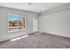 Bright living room with neutral paint, carpet flooring, a large window and a modern ceiling light at 11154 W Ashley Chantil Dr, Surprise, AZ 85378