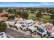 Aerial view of homes with solar panels, surrounded by mature trees and golf course at 11633 N 40Th Way, Phoenix, AZ 85028