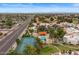An aerial view highlights the pool, tennis court, community landscaping, and surrounding neighborhood at 11633 N 40Th Way, Phoenix, AZ 85028