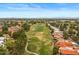 An aerial view showcases lush golf course surroundings, community landscaping, and nearby residential properties at 11633 N 40Th Way, Phoenix, AZ 85028