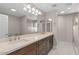 Bathroom with double vanity, large mirror, stylish lighting, and walk-in shower at 11633 N 40Th Way, Phoenix, AZ 85028