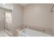 Bright bathroom featuring a large bathtub, tile surround, and separate shower at 11633 N 40Th Way, Phoenix, AZ 85028