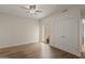 Bedroom with wood floors, a ceiling fan, closet doors, and sliding glass doors to the patio at 11633 N 40Th Way, Phoenix, AZ 85028