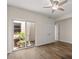 Bright bedroom with hardwood floors, a ceiling fan and sliding door to the courtyard at 11633 N 40Th Way, Phoenix, AZ 85028