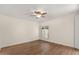Neutral bedroom featuring wood floors, white walls, ceiling fan and plantation shutters at 11633 N 40Th Way, Phoenix, AZ 85028