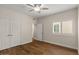Bright bedroom boasts hardwood floors, a ceiling fan, and natural light from a window at 11633 N 40Th Way, Phoenix, AZ 85028