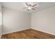 Cozy bedroom featuring hardwood floors and a modern ceiling fan fixture at 11633 N 40Th Way, Phoenix, AZ 85028