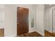 A warm entry with a rich wood door, sidelight, and beautiful hardwood floors at 11633 N 40Th Way, Phoenix, AZ 85028