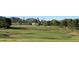 Expansive golf course view featuring a vibrant green, manicured lawn, picturesque mountain views, and a blue flag marker at 11633 N 40Th Way, Phoenix, AZ 85028